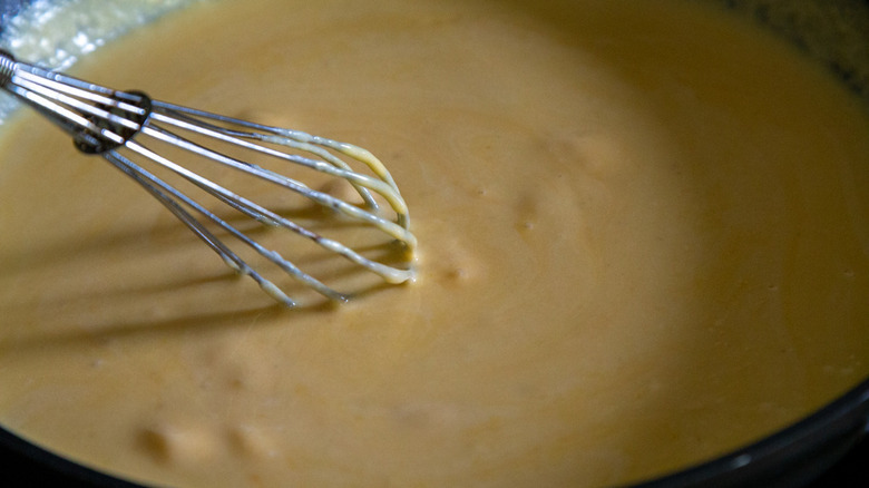 cheese sauce and whisk