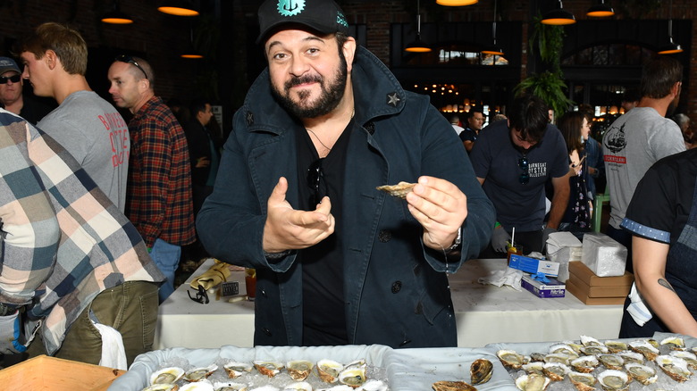 Adam Richman holding oyster