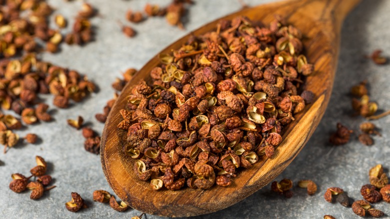 Szechuan peppercorns on wooden spoon