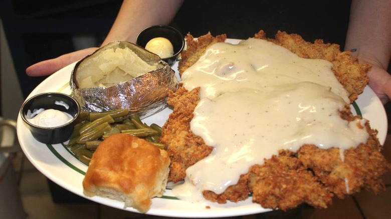 Chicken fried steak with gravy and potato