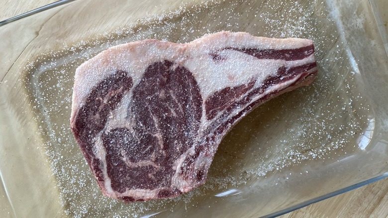 Salted beef steak in glass tray