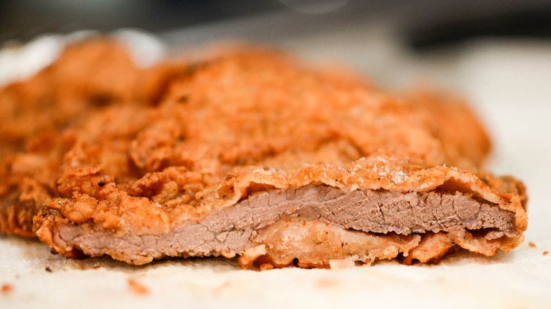 Thin battered beefsteak, sliced open