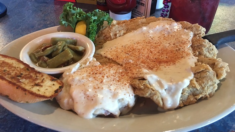 Seasoned gravy on plated chicken fried steak