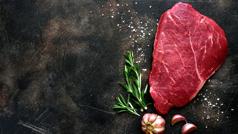 Raw steak on counter