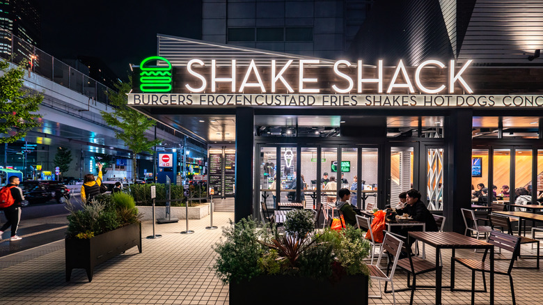 A Shake Shack lit up at night