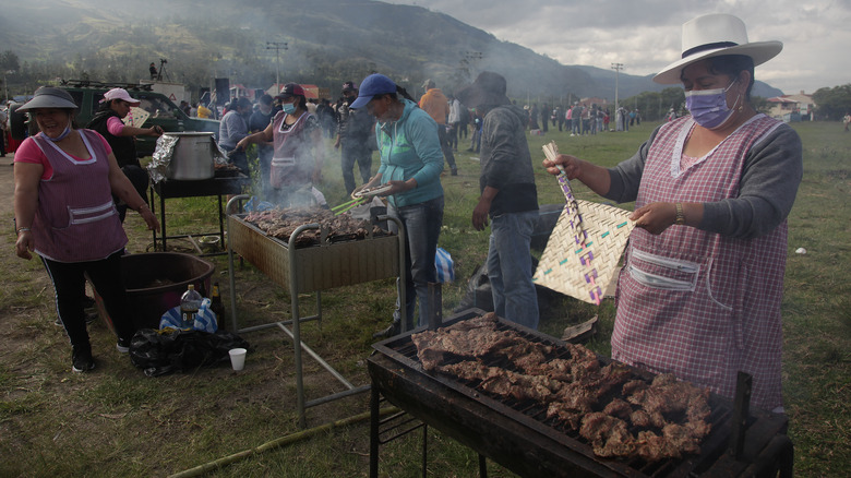 Ecuadorean cooks grilling meat