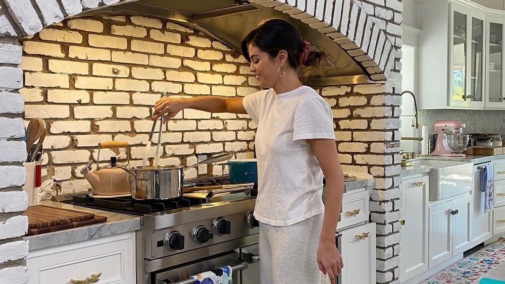 Selena Gomez stirring over the stove