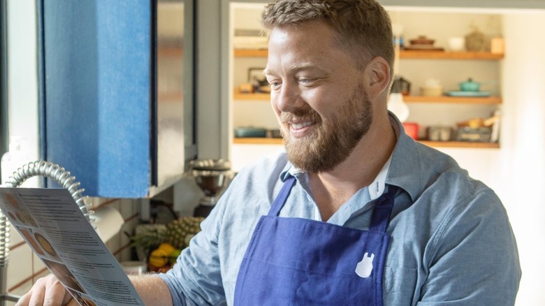 Tim Hollingsworth looking at a menu