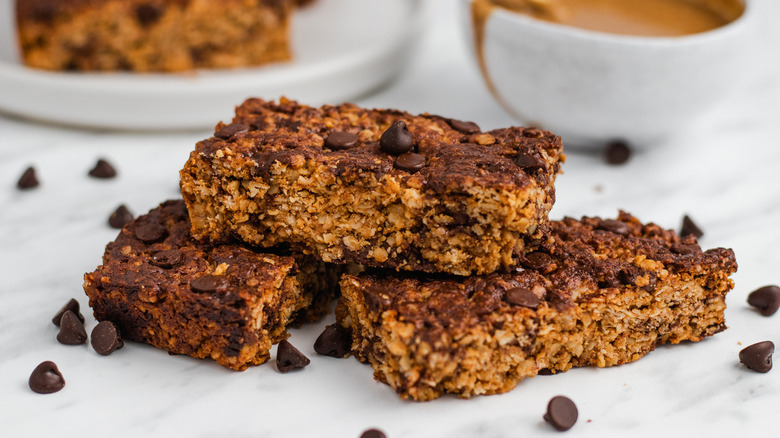 Peanut butter granola bars with bowl of something