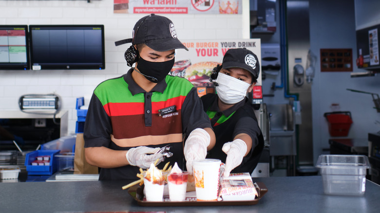 Burger King employees filling a tray