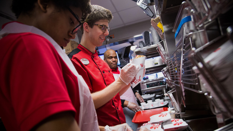 Chick-fil-A workers preparing order in kitchen