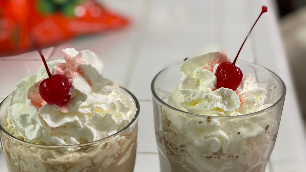 Milkshake tops with cherry and whipped cream