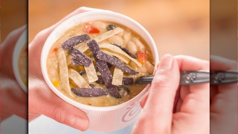 Hands holding cup of Chick-fil-A tortilla soup