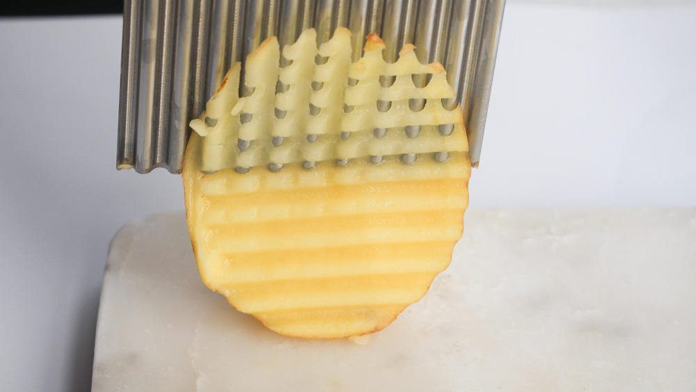 using a waffle cutter to slice potatoes