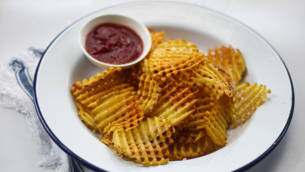 Finished fries on a plate with ketchup