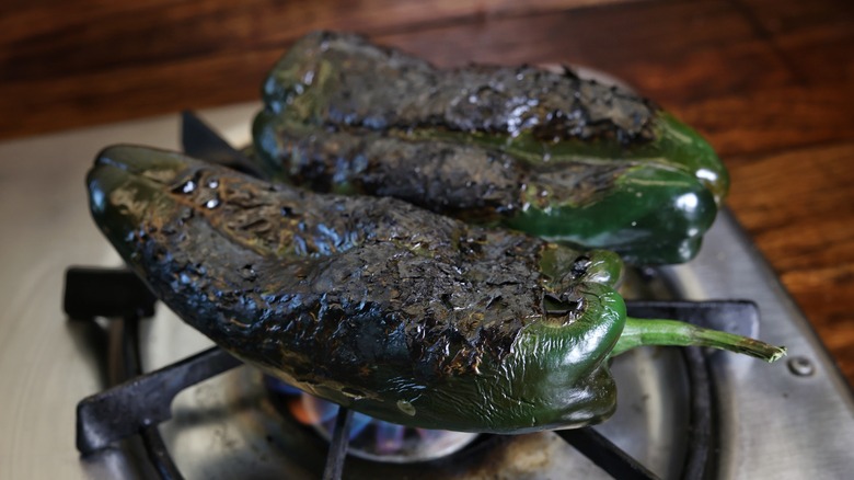 poblanos roasting on stovetop