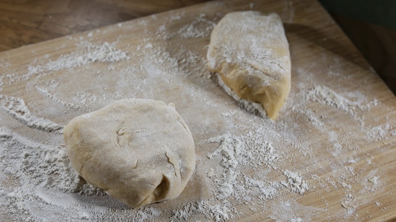 two dough balls on cutting board