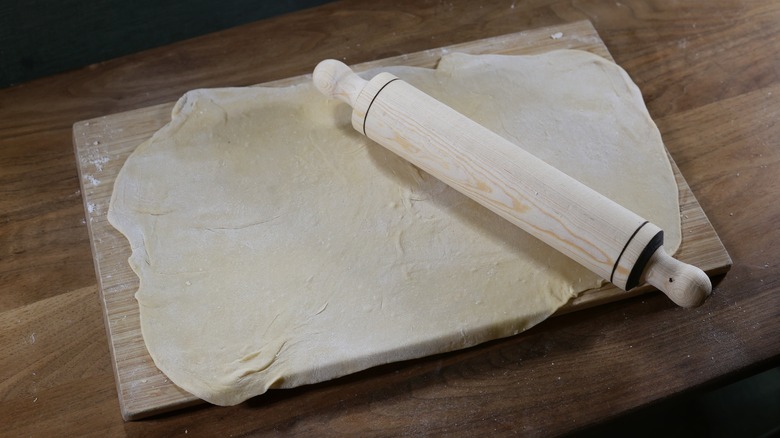 rolling pin on sheet of pasta dough