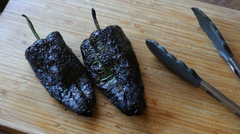 roasted poblanos on cutting board