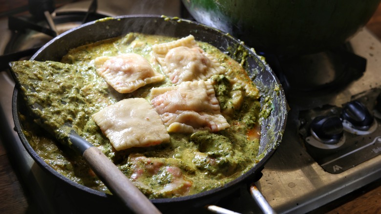 skillet of sauce and ravioli