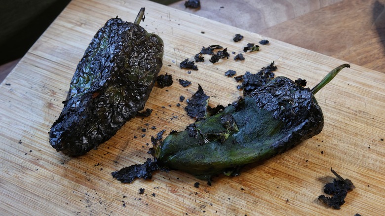 half-peeled roasted poblanos