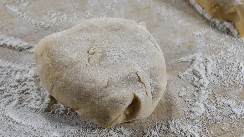 ball of pasta dough on floured board