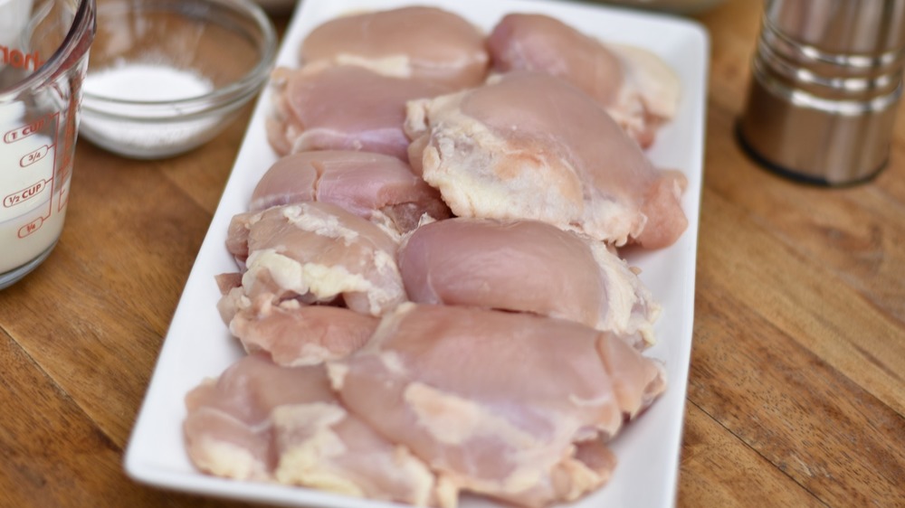 Raw chicken thighs on counter