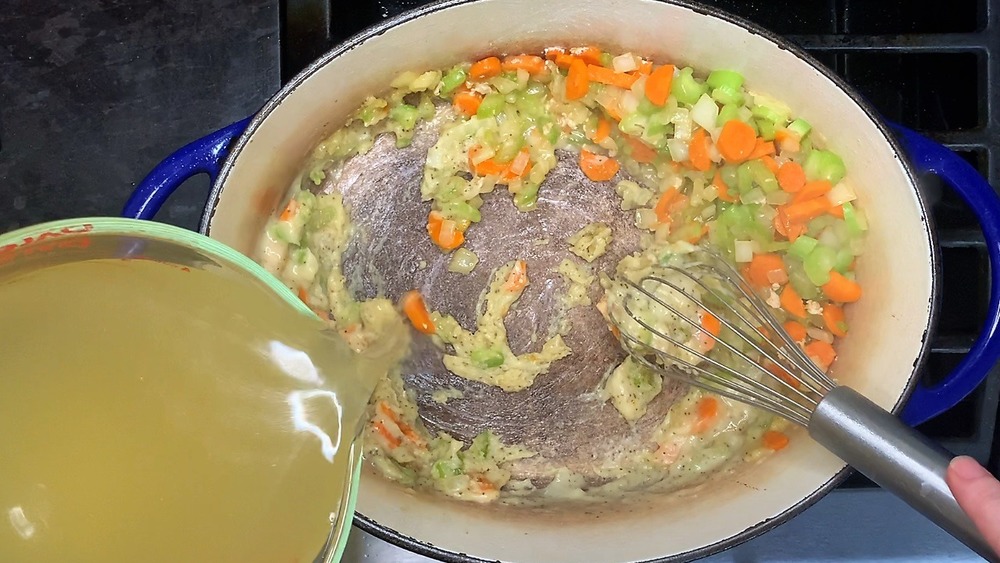 Chicken stock being added to pan