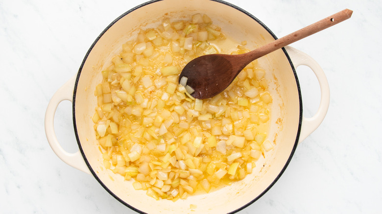 Onion and garlic sauteing in casserole pot