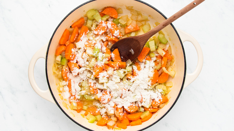 Veg and flour sauteing in casserole pot