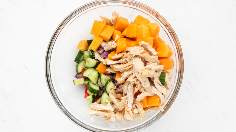 chicken melon salad ingredients in mixing bowl