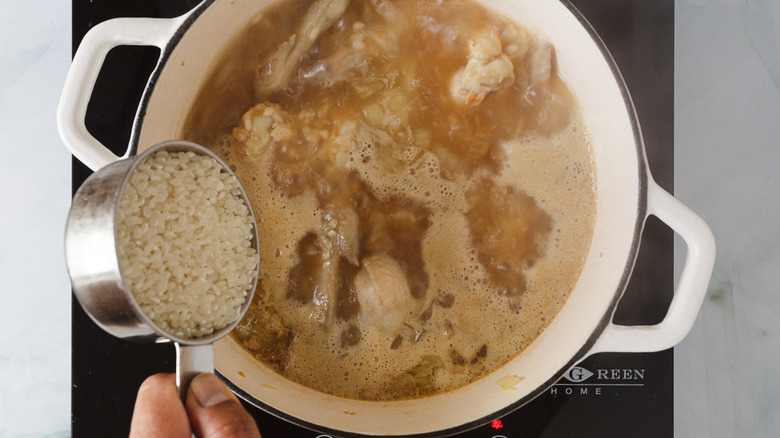 cup of rice added into boiling pot