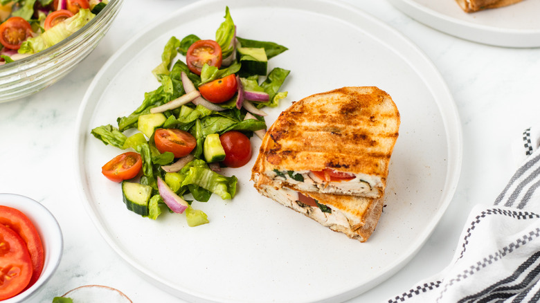 chicken caprese panini and salad on plate