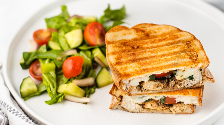 chicken caprese panini and salad on plate