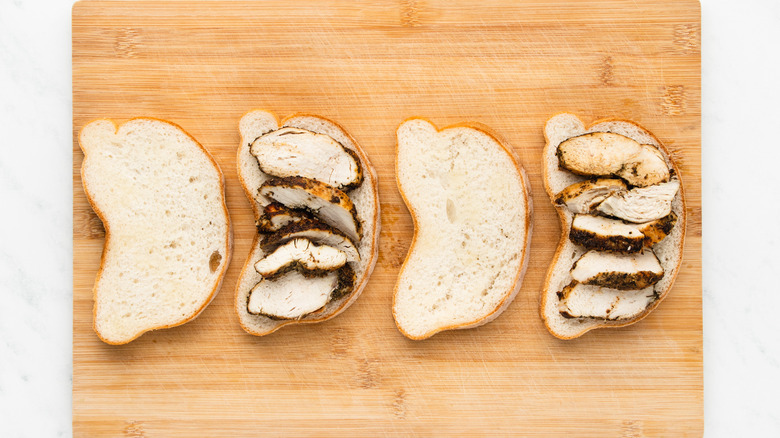 open chicken sandwiches on cutting board