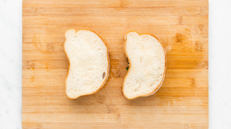 two sandwiches on cutting board