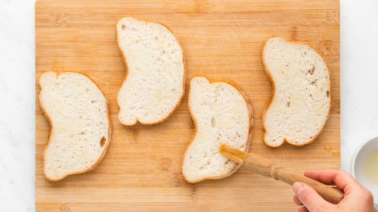 brushing bread slices with oil