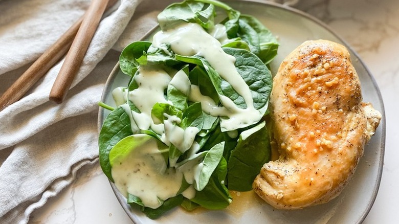 Cooked chicken breast with dressed salad