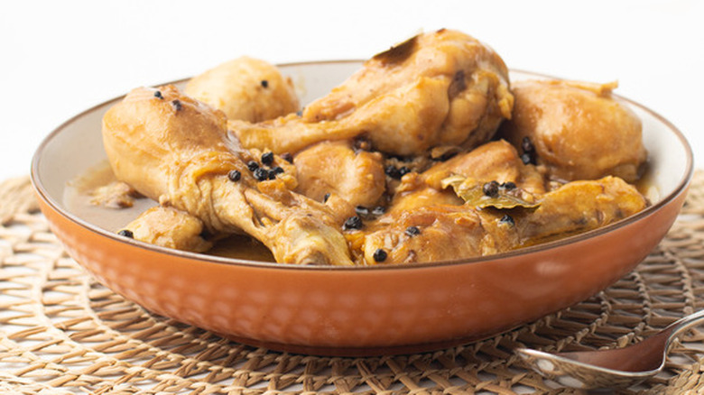 Cooked chicken drumsticks in a brown bowl