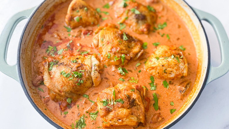 Chicken pieces in a red paprika broth