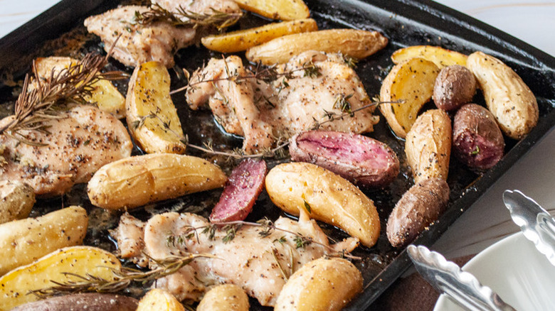 Chicken, potatoes and herbs on sheet pan