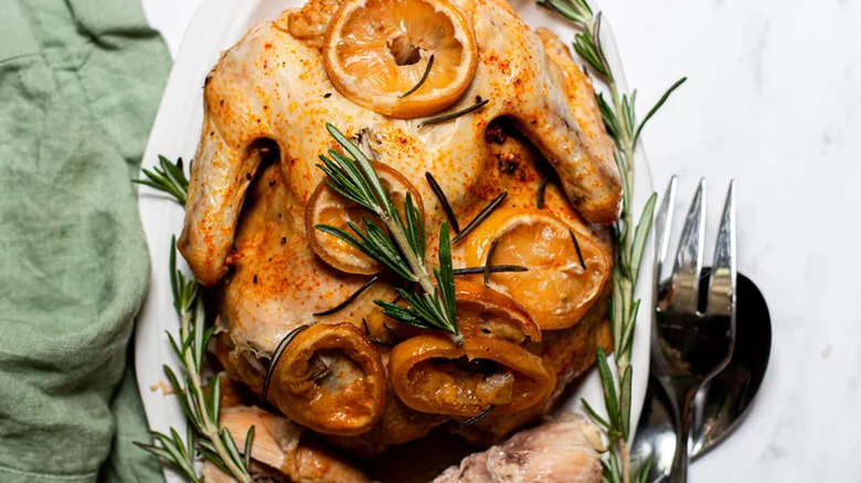 Whole chicken topped with lemon slices