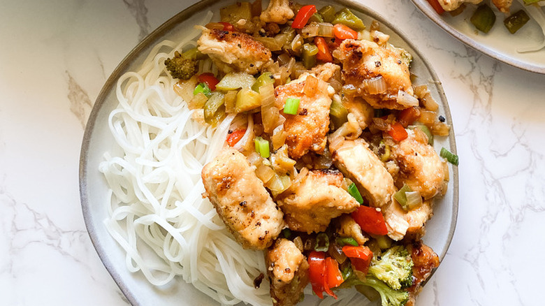 Plate with noodles and chicken stir fry