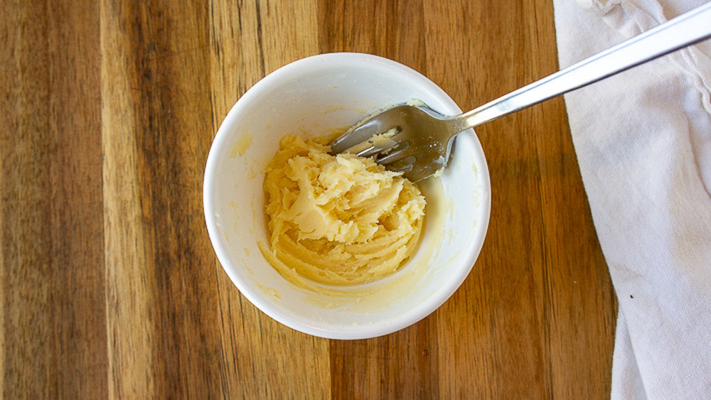 white bowl with a yellow paste and fork