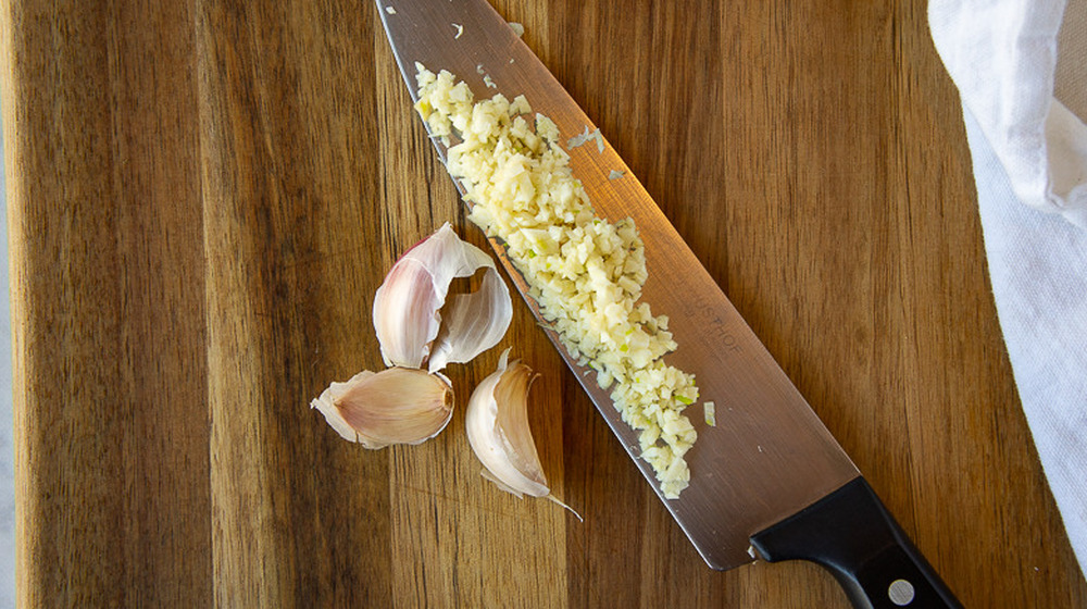 chef's knife with minced garlic