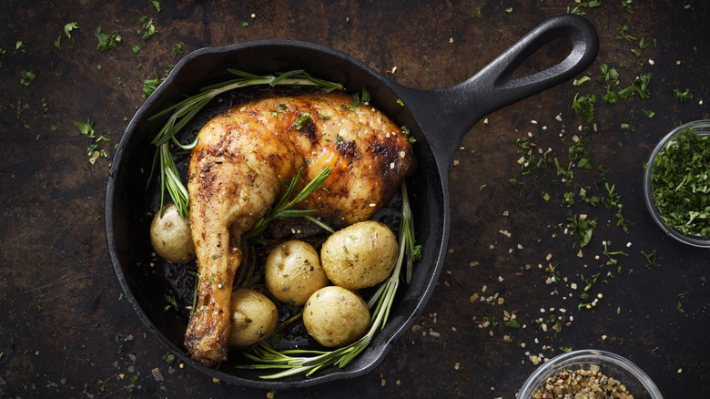 Chicken thigh in pan with potatoes