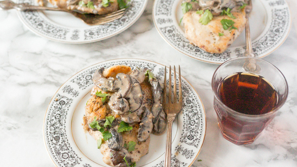 chicken marsala on plate with wine