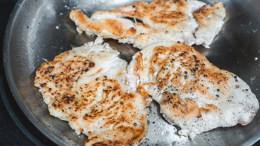 frying chicken in pan