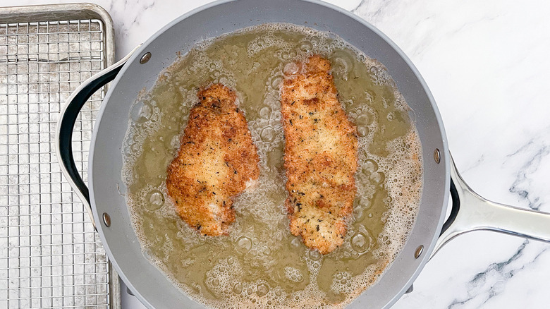 chicken frying in skillet 