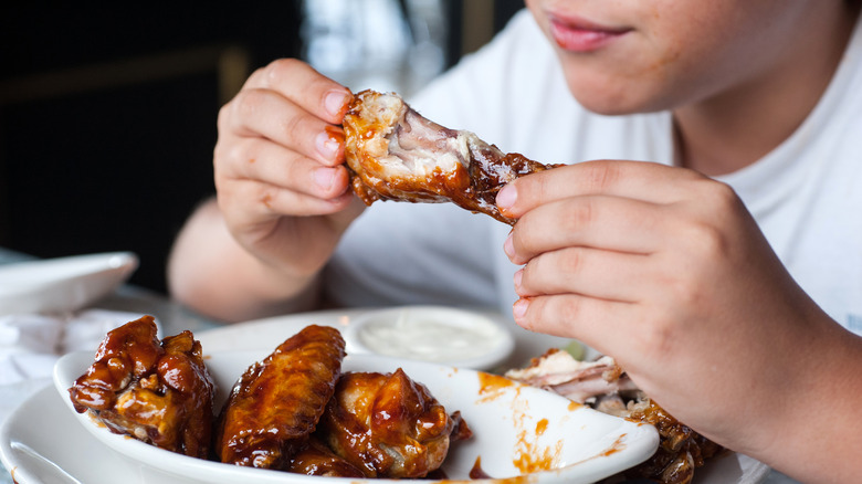 messy eating chicken wings